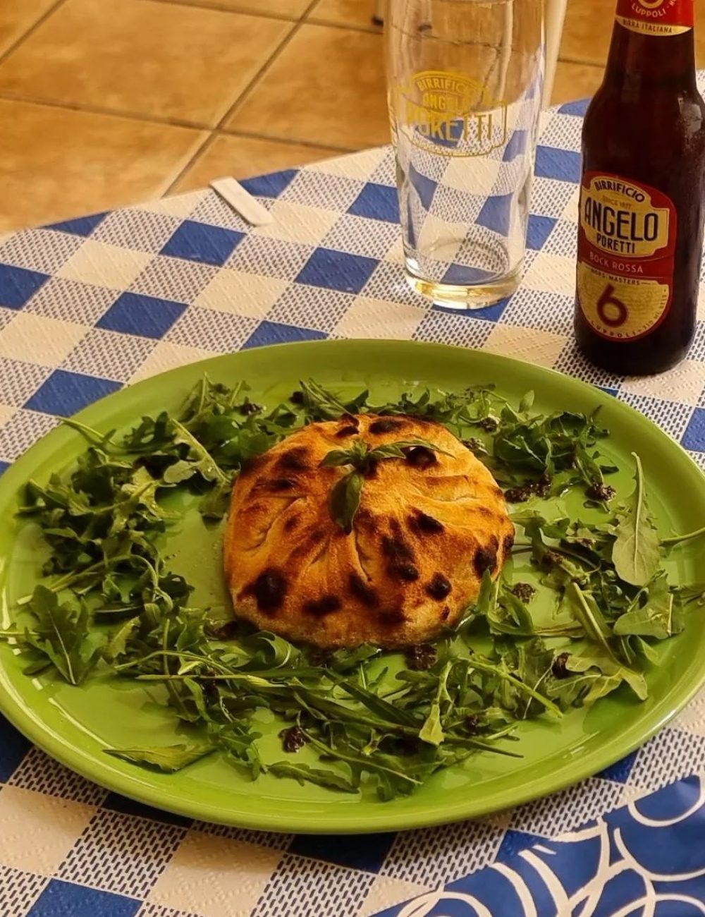 Pizza individual servida con cerveza artesanal en una pizzería italiana en Fuengirola